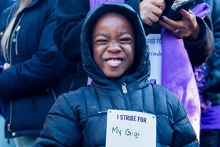 Young boy smiling at Purplestrike event
